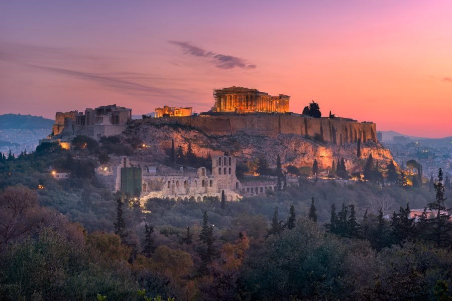 The Acropolis of Athens glowing in soft early morning light with the Parthenon under a calm sky.