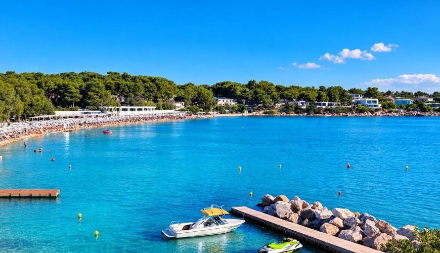 View of the Athens Riviera coastline south of Athens with clear blue water, boats and beach.