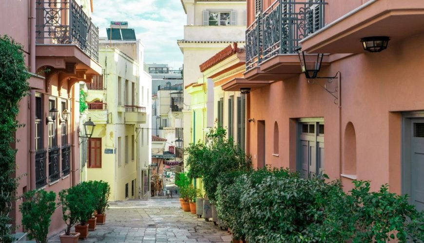 Quiet neoclassical street in Athens with pastel buildings and greenery, reflecting a calm, local walking experience