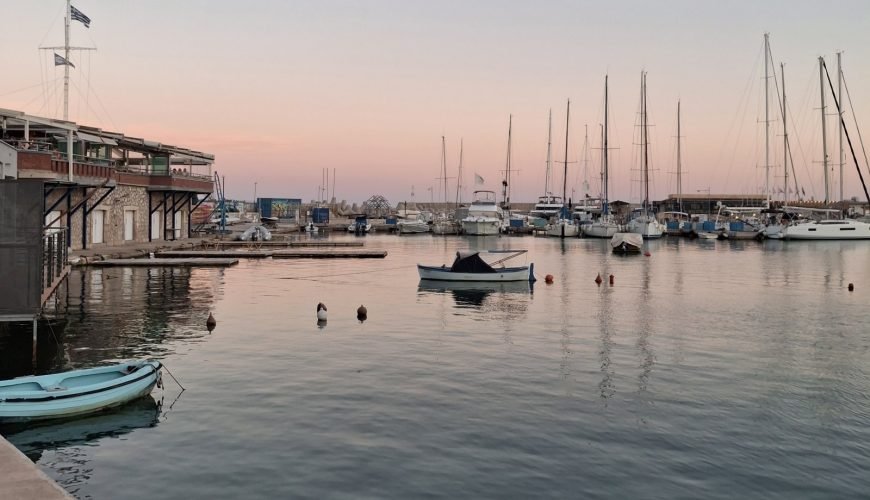 Evening marina in Piraeus with sailboats and calm water at sunset