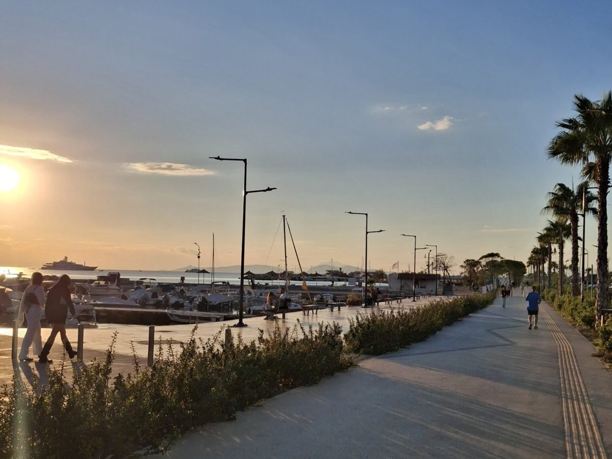 Palm-lined waterfront promenade in Glyfada, Athens Riviera, with marina views at sunset